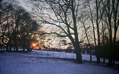 A view taken in the 1960s of snow covered   countryside near Henley   with the sun rising/setting (?) in the distance.    Photo kindly provided by Roy Sadler.  